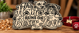 Custom wooden dog-themed sign featuring two illustrated Boxer dogs, paw prints, hearts, and the phrase This Home Runs on Boxer Love, displayed on a rustic wooden workbench.