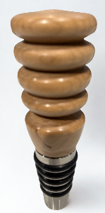 Wooden bottle stopper with stacked rings on a white background