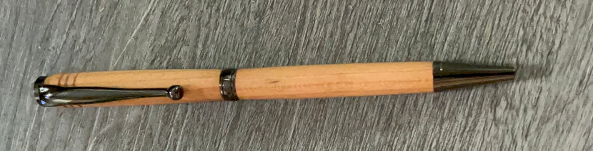 Wooden pen with black accents on a gray textured surface