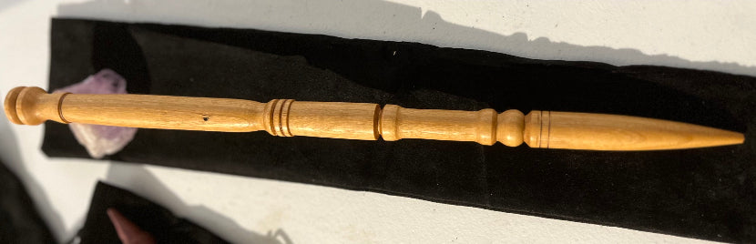 Wooden wand with a pointed end on a black background