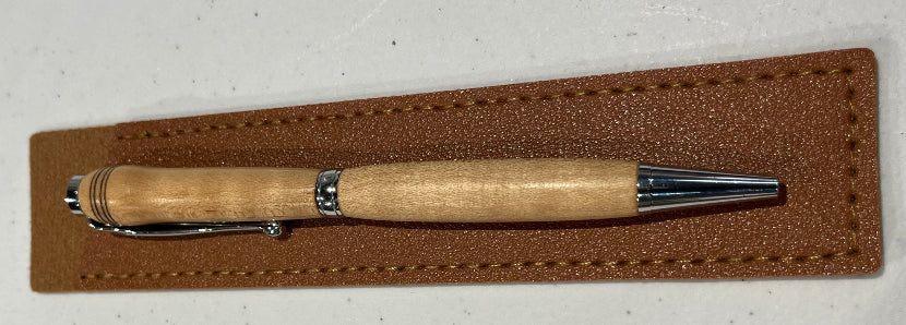 Wooden pen with silver accents on a brown leather pouch